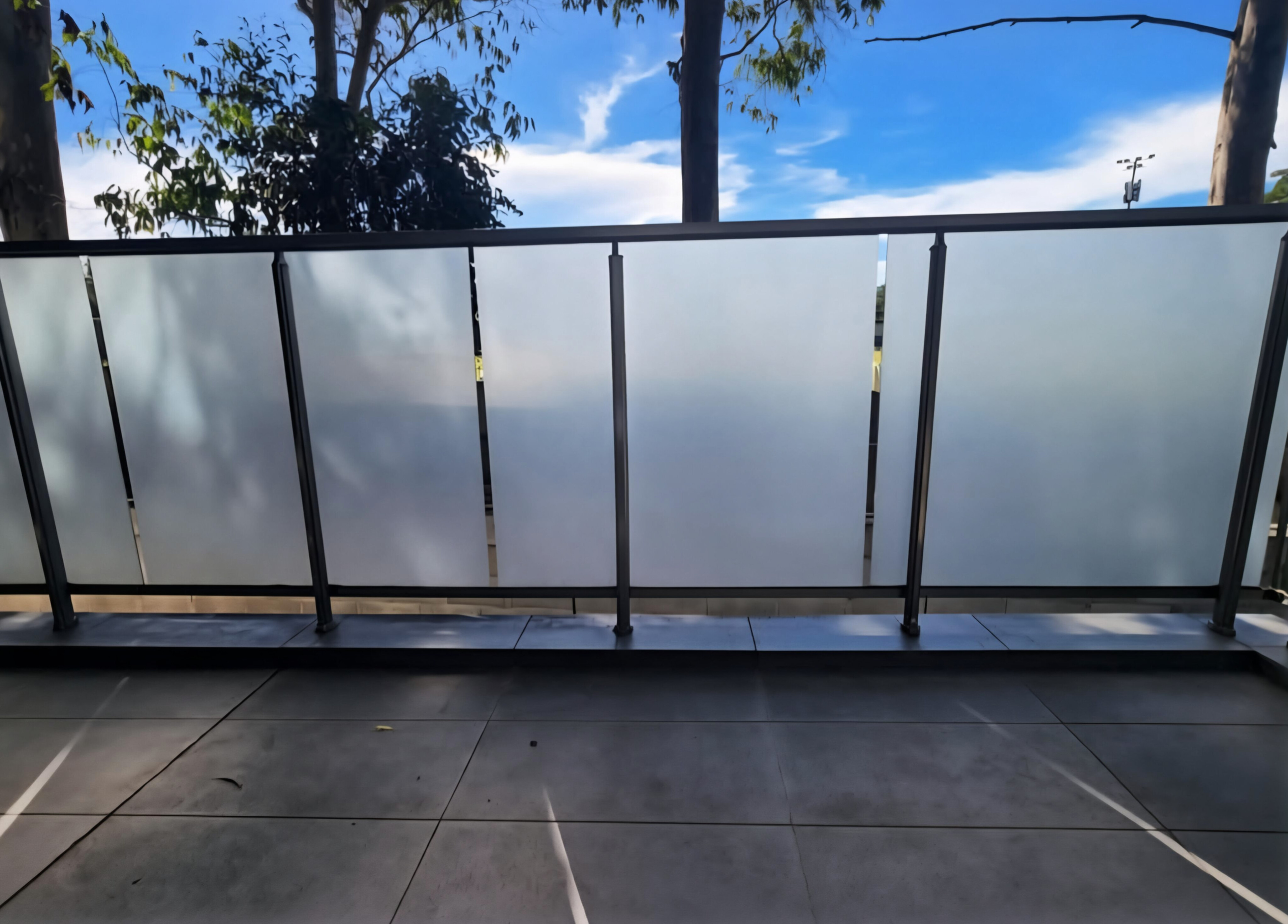 Frosted privacy film on full glass balustrade balcony panels in Manly Northern Beaches — TMC Tinting